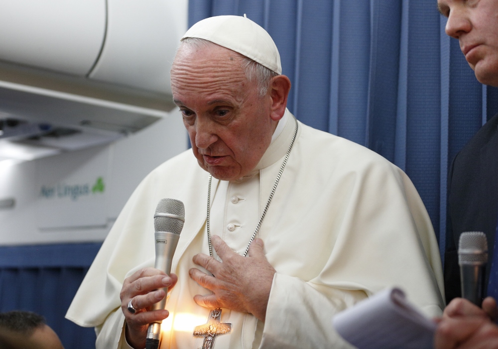Pope Francis responds to a question from a reporter aboard his flight from Dublin to Rome Aug. 26. (CNS/Paul Haring)