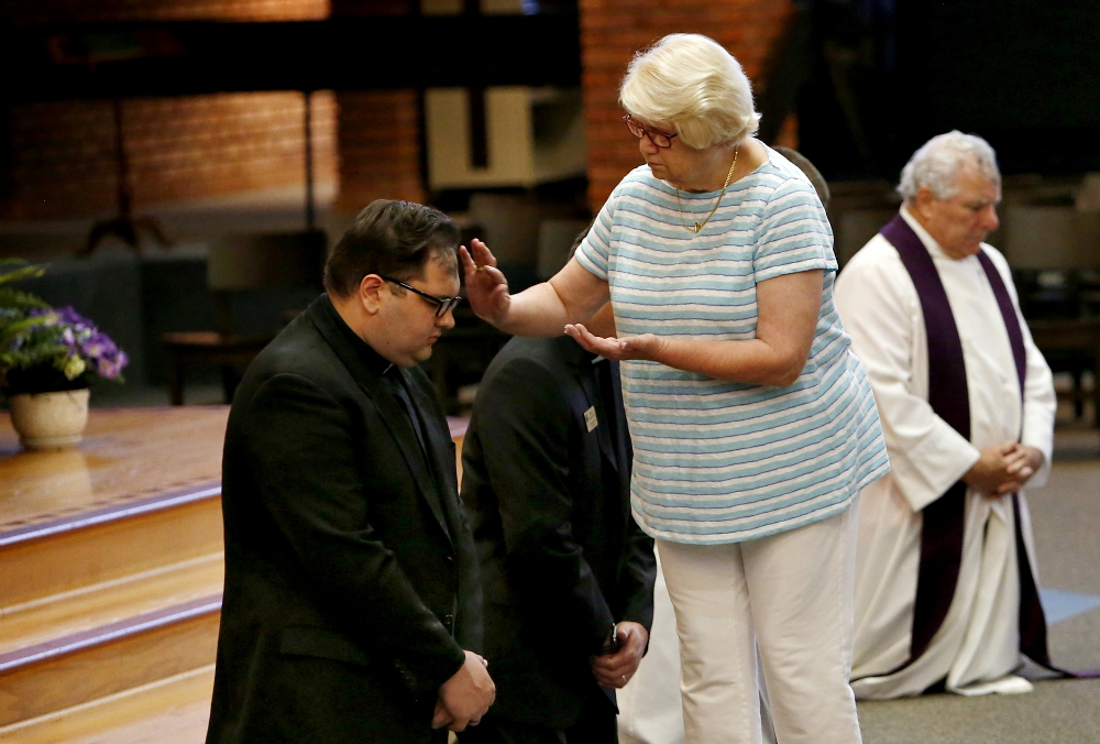 A woman administers ashes on the forehead of a priest during a prayer service for repentance and healing for clergy sexual abuse Aug. 22 at Our Lady of the Brook in Northbrook, Illinois. (CNS/Chicago Catholic/Karen Callaway) A woman administers ashes on the forehead of a priest during a prayer service for repentance and healing for clergy sexual abuse Aug. 22 at Our Lady of the Brook in Northbrook, Illinois. (CNS/Chicago Catholic/Karen Callaway)