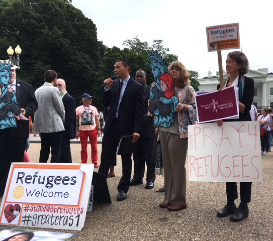 Catholics join other religious organizations and groups near the White House in Washington Sept. 12 urging the administration to allow 75,000 refugees into the country next fiscal year. (CNS/Rhina Guidos)