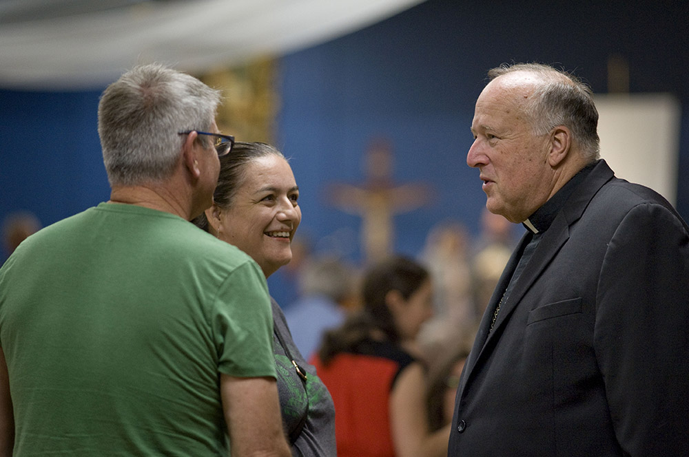 Bishop Robert McElroy chats with attendees arriving for a listening session on the issue of clergy sexual abuse Oct. 1, 2018, at Our Mother of Confidence Parish Hall in San Diego. (CNS/David Maung)