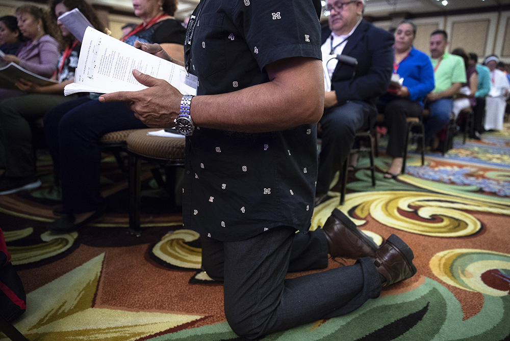 A delegate prays Sept. 23, 2018, during the Fifth National Encuentro in Grapevine, Texas. (CNS/Tyler Orsburn)
