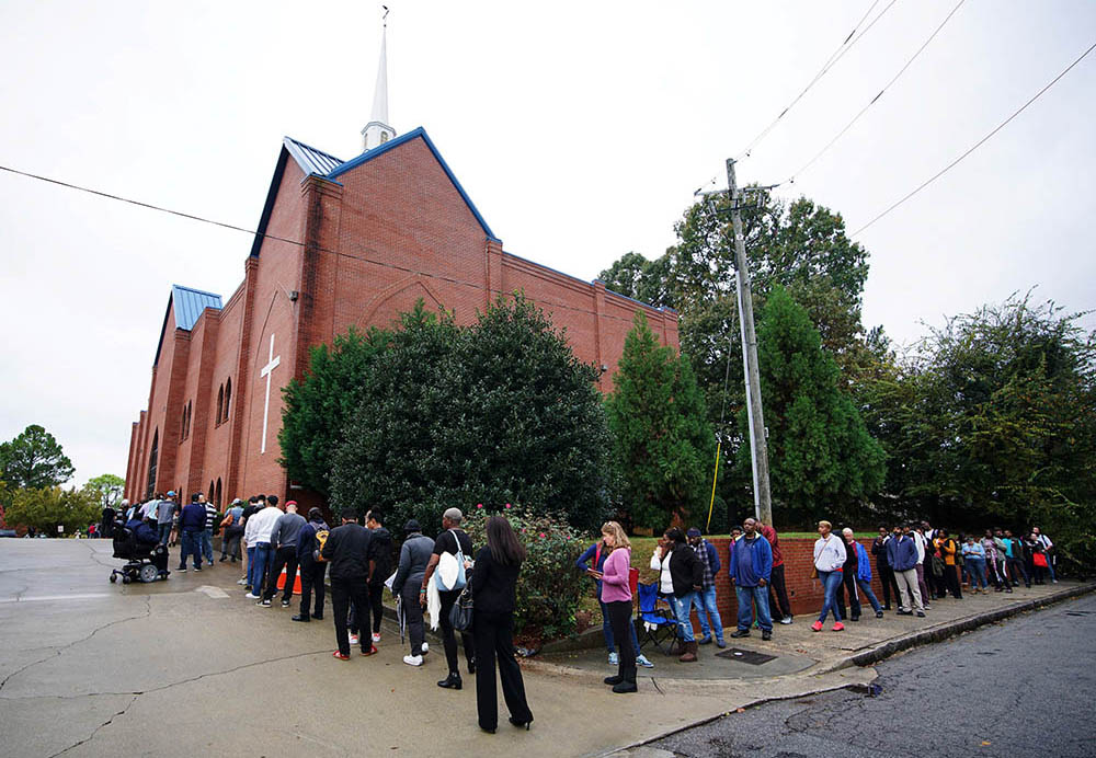 A line of voters wraps around Our Lady of Lourdes Catholic Church in Atlanta during midterm elections Nov. 6, 2018. (CNS/Reuters/Lawrence Bryant)