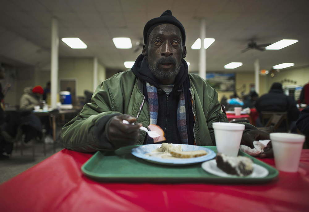 A man eats his lunch at a soup kitchen in the basement of St. Leo Catholic Church in Detroit. (CNS/Reuters/Mark Blinch) A man eats his lunch at a soup kitchen in the basement of St. Leo Catholic Church in Detroit. (CNS/Reuters/Mark Blinch)