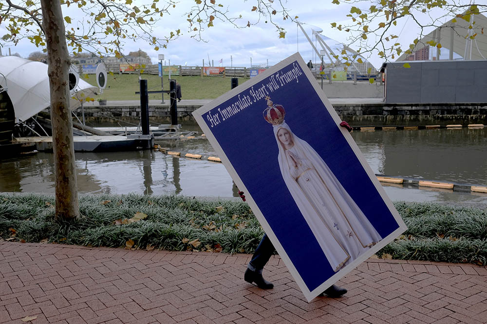 A protester carries a placard Nov. 13, 2018, for a rally sponsored by Church Militant in Baltimore during that year's fall meeting of the U.S. Conference of Catholic Bishops. (CNS/Tennessee Register/Rick Musacchio)