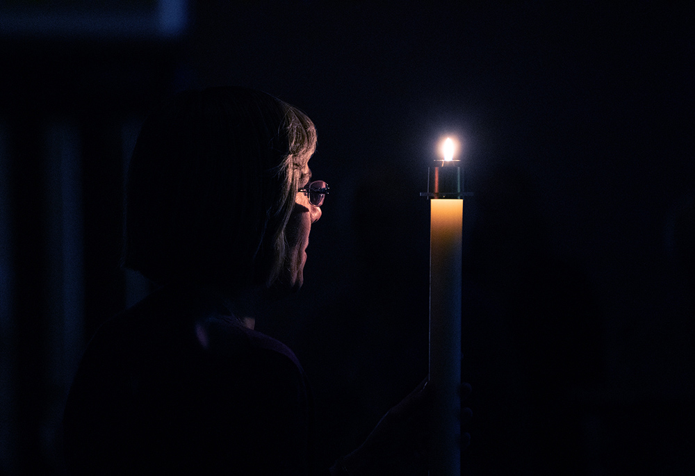 Benedictine Sr. Jennifer Mechtild Horner, prioress of the Sisters of St. Benedict of Beech Grove, Indiana, holds a candle symbolizing the light of Christ during a prayer service at the Our Lady of Grace Monastery Dec. 1, 2018. (CNS/Katie Rutter)