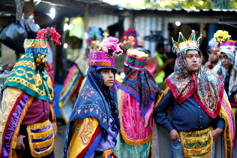 Members of the traditional group of "Los Historiantes" gather outside a house as they celebrate the feast of the Epiphany Jan. 6, 2019, in San Salvador, El Salvador. (CNS/Reuters/Jose Cabezas)