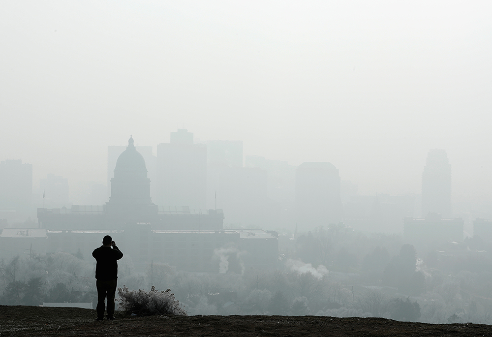 A man stops to take a picture of the Utah State Capitol and buildings that are shrouded in smog in downtown Salt Lake City Dec. 12, 2017. (CNS/Reuters/George Frey) A man stops to take a picture of the Utah State Capitol and buildings that are shrouded in smog in downtown Salt Lake City Dec. 12, 2017. (CNS/Reuters/George Frey)