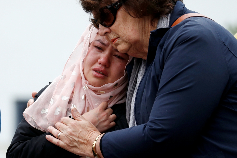People embrace as they pay respects outside Al Noor Mosque in Christchurch, New Zealand, March 18. (CNS/Reuters/Jorge Silva)