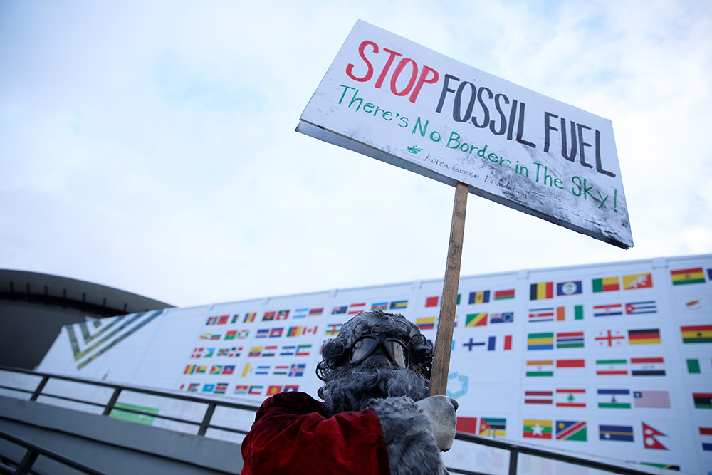 An environmental activist protests against fossil fuel outside the COP24 U.N. Climate Change Conference in Katowice, Poland, Dec. 10, 2018. (CNS/Reuters/Agencja Gazeta/Grzegorz Celejewski)