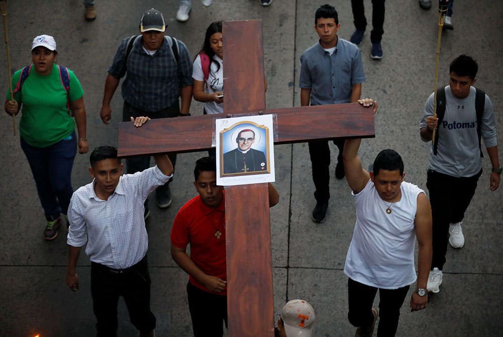 People participate in a March 23, 2019, procession to commemorate the 39th anniversary of the murder of St. Oscar Romero in San Salvador, El Salvador. The Salvadoran saint was shot and killed March 24, 1980, as he celebrated Mass. (CNS/Reuters/Jose Cabeza