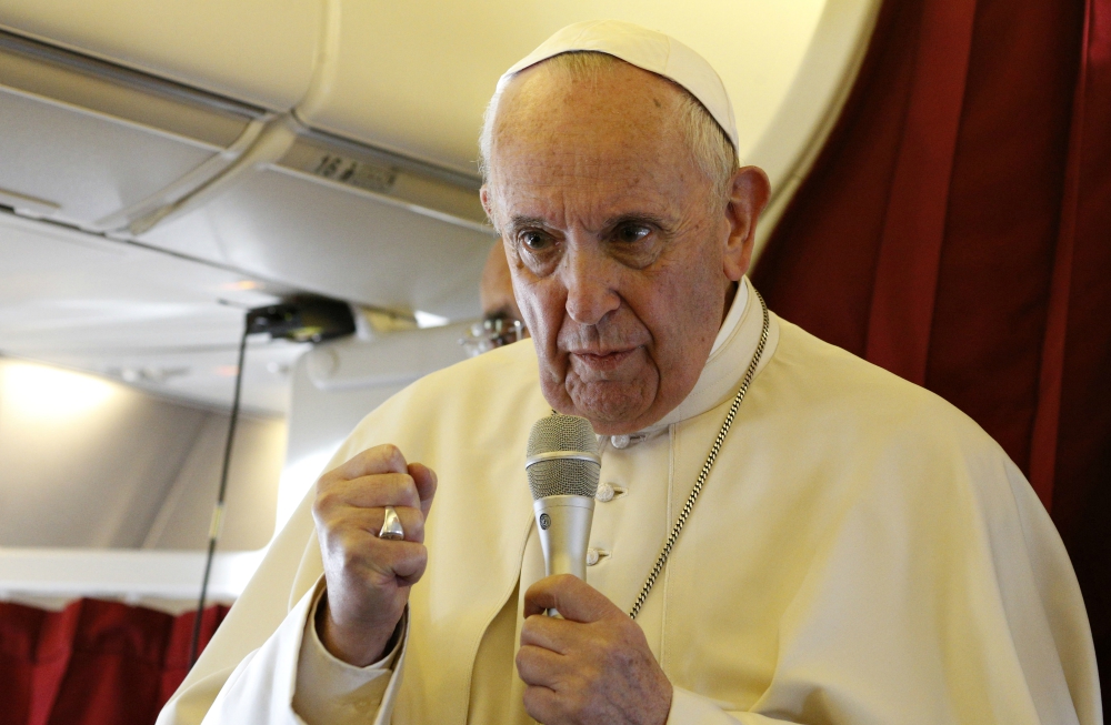 Pope Francis answers questions from journalists aboard his flight from Rabat, Morocco, to Rome March 31. (CNS/Paul Haring)