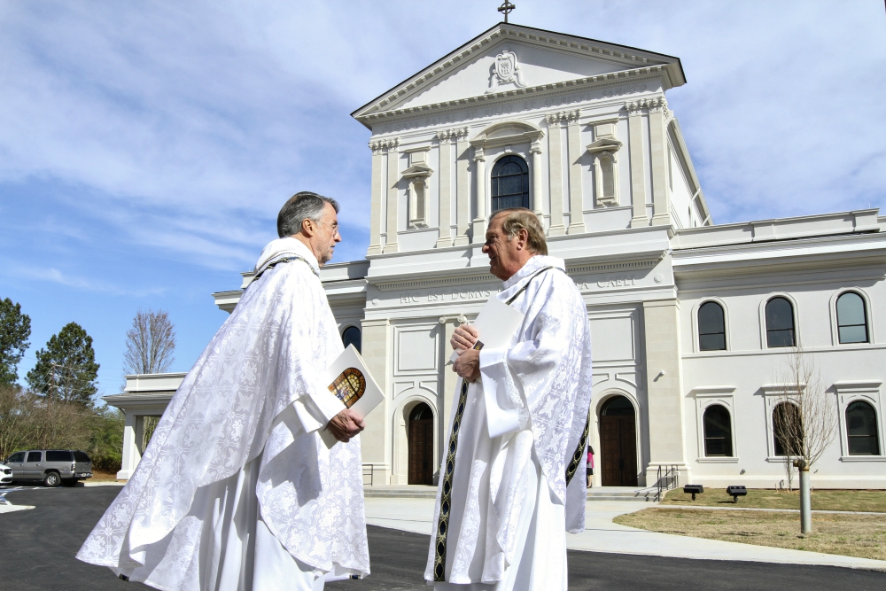 Fr. David Dye, retired administrator of Mary Our Queen Church in Peachtree Corners, Georgia, and Fr. Francis "Butch" Mazur, the last pastor of St. Gerard Church in Buffalo, New York, discuss the new Mary Our Queen Church in the background. (CNS) Fr. David Dye, retired administrator of Mary Our Queen Church in Peachtree Corners, Georgia, and Fr. Francis "Butch" Mazur, the last pastor of St. Gerard Church in Buffalo, New York, discuss the new Mary Our Queen Church in the background. (CNS)