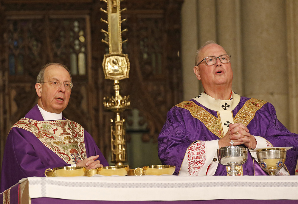 Baltimore Archbishop William E. Lori, left, and New York Cardinal Timothy Dolan concelebrate Mass April 7, 2019, at St. Patrick's Cathedral in New York City. (CNS/Gregory A. Shemitz)