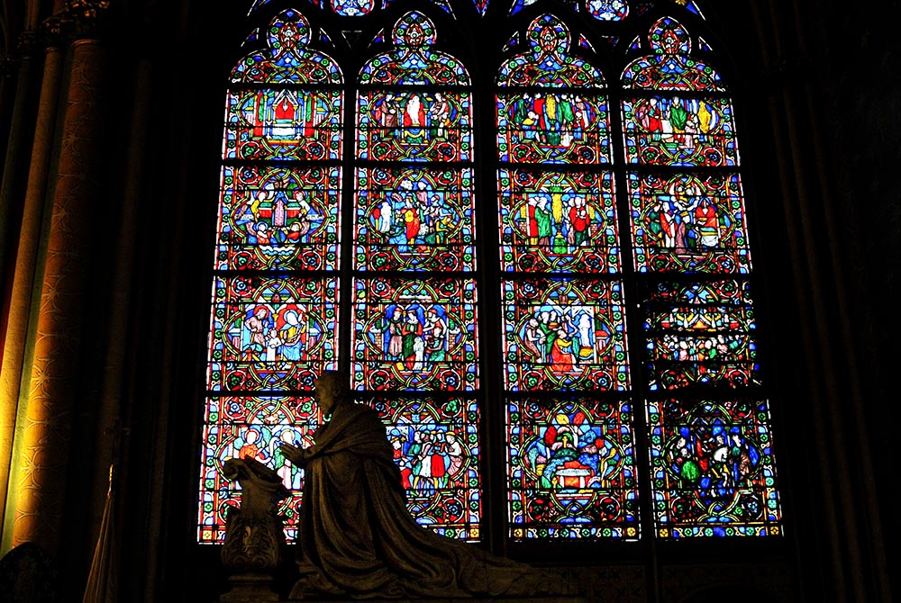 Statues are silhouetted in front of stained-glass windows inside the Notre Dame Cathedral in 2013 Statues are silhouetted in front of stained-glass windows inside the Notre Dame Cathedral Feb. 2, 2013, in Paris. (CNS/Gerard Roussel, Panoramic via Reuters)
