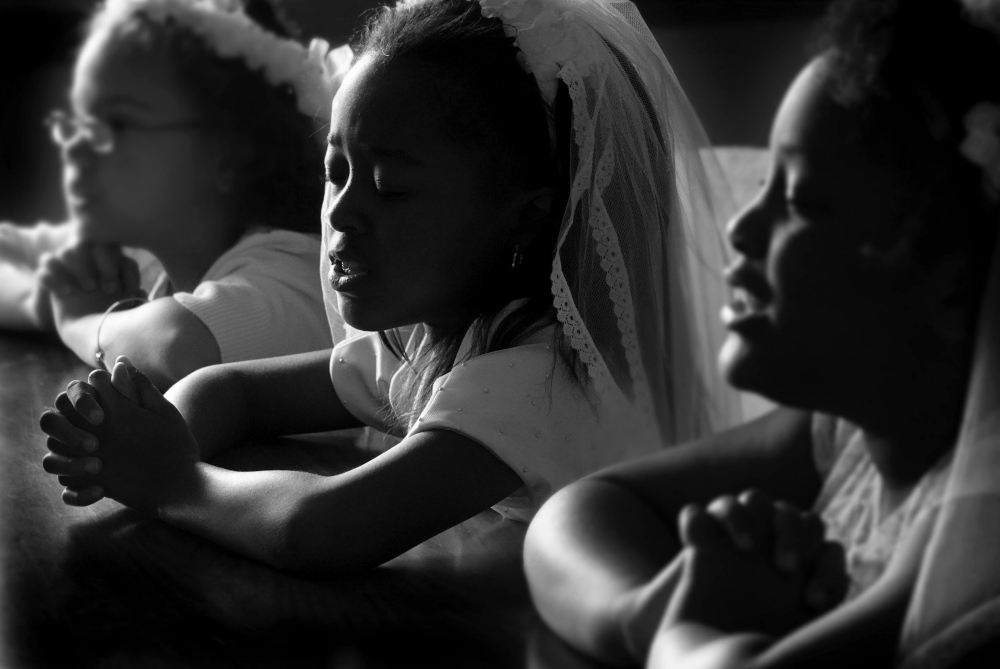 Children at St. Augustine Catholic Church in Memphis, Tennessee, pray during their first Communion May 19. (CNS/Karen Focht) Children at St. Augustine Catholic Church in Memphis, Tennessee, pray during their first Communion May 19. (CNS/Karen Focht)