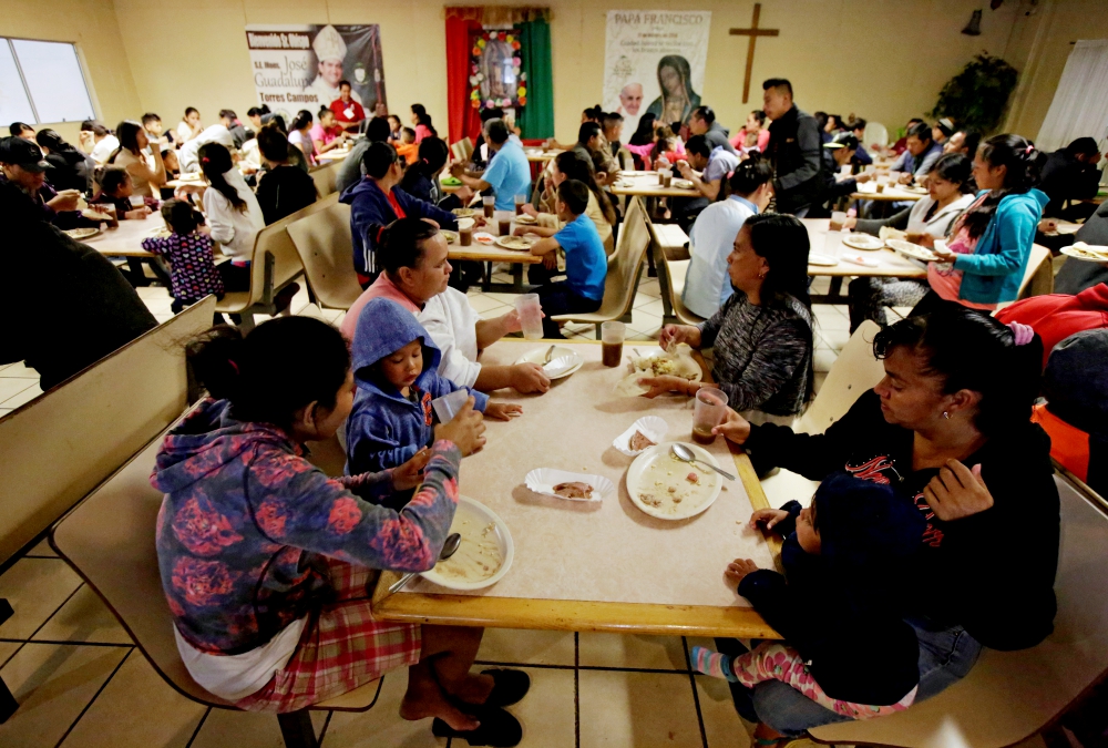 Migrants eat at a Catholic-run shelter in Ciudad Juárez, Mexico, May 10 (CNS/Reuters/Jose Luis Gonzalez)