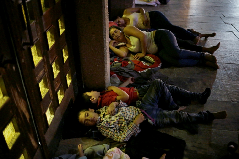 Central American migrants sleep outside Our Lady of Guadalupe Cathedral in Ciudad Juárez, Mexico, July 14. (CNS/Reuters/Jose Luis Gonzalez)