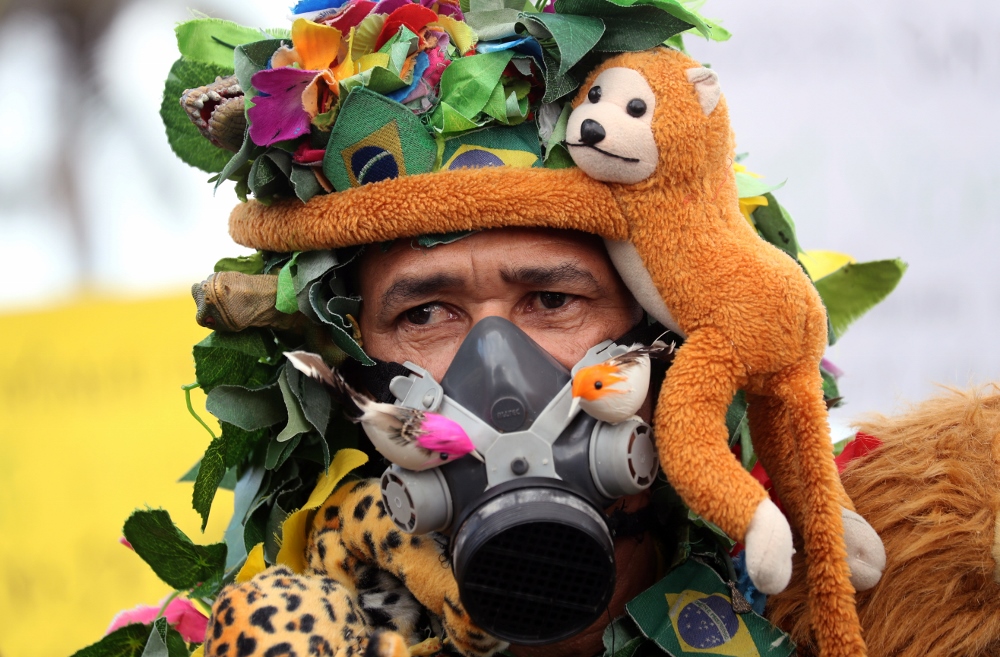 An Amazon rainforest advocate is seen wearing a gas mask in Rio de Janeiro Aug. 25. (CNS/Reuters/Sergio Moraes)