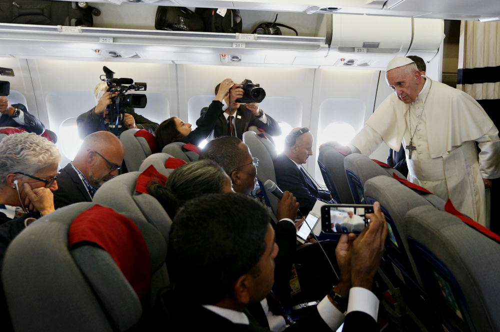Pope Francis answers questions from journalists aboard his flight from Antananarivo, Madagascar, to Rome Sept. 10. (CNS/Paul Haring)