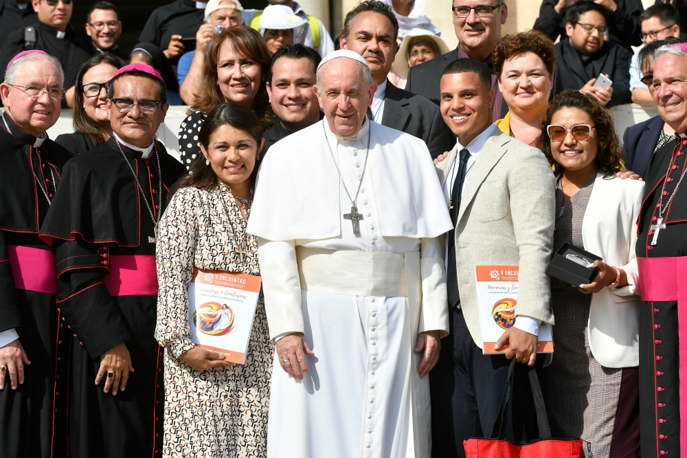 Pope Francis poses for a photo Sept. 18 with members of a U.S. delegation that traveled to Rome to present the results of V Encuentro at the Vatican. Los Angeles Archbishop José Gomez, leader of the delegation, is seen at the far left. (CNS)