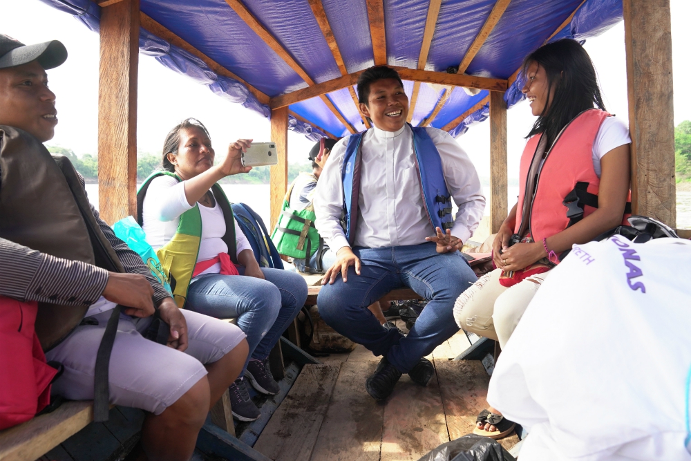 Deacon Ferney Pereira and members of his Colombian parish take a boat on a river in the Amazon Sept. 8. (CNS/Manuel Rueda) 