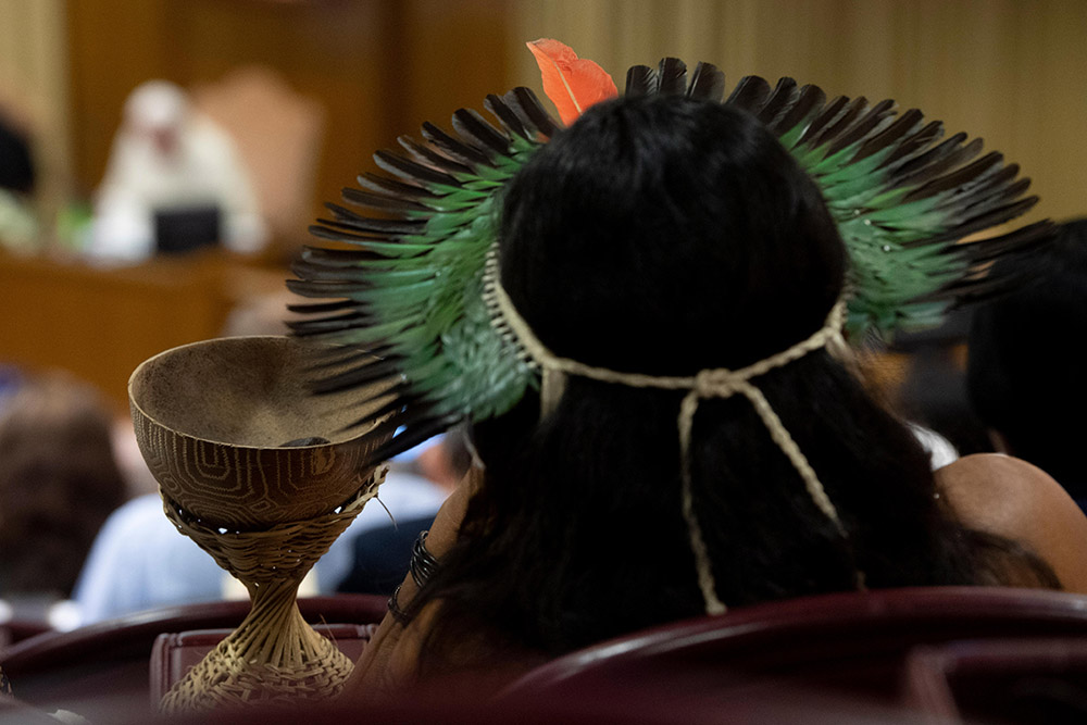 An indigenous person attends a session of the Synod of Bishops for the Amazon at the Vatican Oct. 8, 2019. (CNS/Vatican Media)