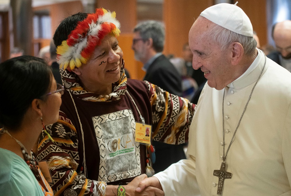 Pope Francis meets José Gregorio Díaz Mirabal, a member of the Curripaco indigenous community, during a session of the Synod of Bishops for the Amazon at the Vatican Oct. 8, 2019. (CNS/Vatican Media)