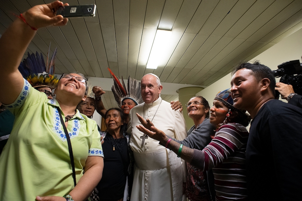 Pope Francis joins in a selfie with Indigenous participants at the Synod of Bishops for the Amazon in October 2019. (CNS photo/Vatican Media) 