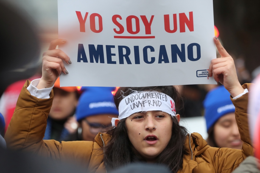 A demonstrator holds a sign outside the U.S. Supreme Court in Washington Nov. 12 as justices hear arguments in a legal challenge to the Trump administration's bid to end the Deferred Action for Childhood Arrivals program. (CNS/Reuters/Jonathan Ernst) A demonstrator holds a sign outside the U.S. Supreme Court in Washington Nov. 12 as justices hear arguments in a legal challenge to the Trump administration's bid to end the Deferred Action for Childhood Arrivals program. (CNS/Reuters/Jonathan Ernst)