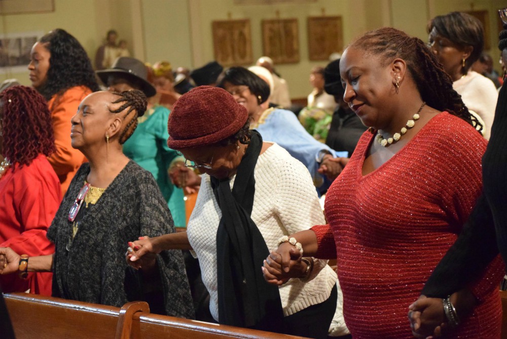 Women pray during Mass Nov. 17, 2019, at St. Therese of Lisieux Church in Brooklyn, New York, in celebration of November as National Black Catholic History Month. (CNS/The Tablet/Andrew Pugliese)