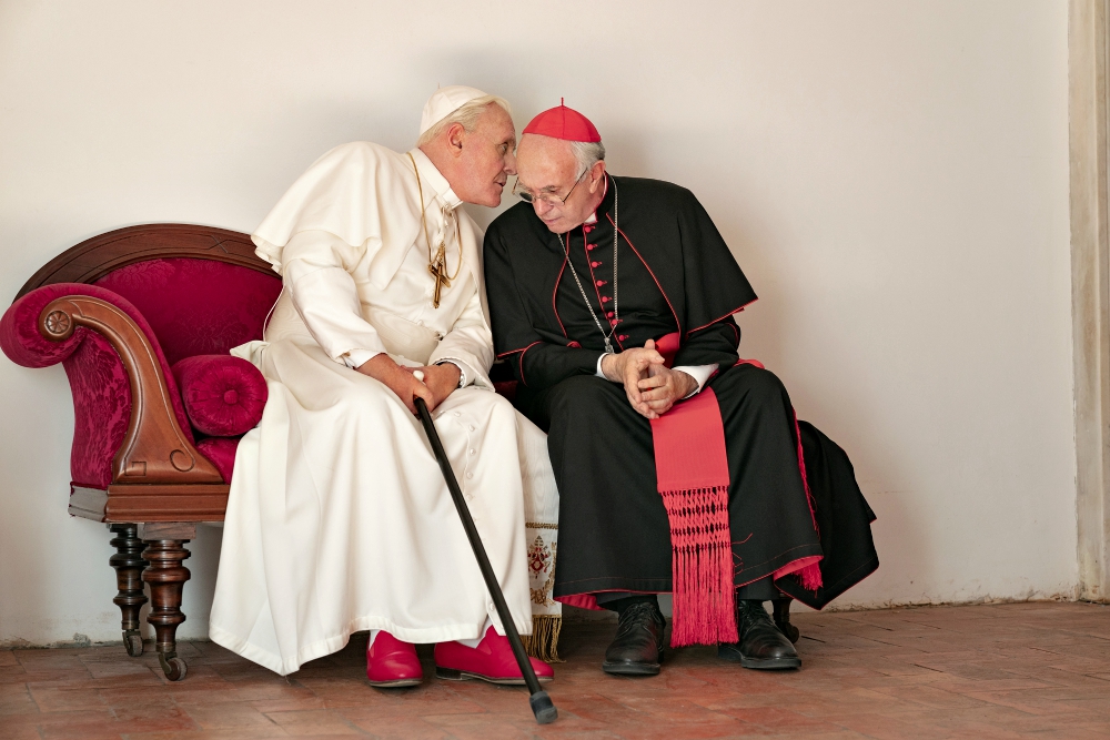 Anthony Hopkins portrays retired Pope Benedict XVI and Jonathan Pryce portrays Pope Francis in a scene from the movie "The Two Popes." (CNS/Courtesy of Netflix /Peter Mountain)