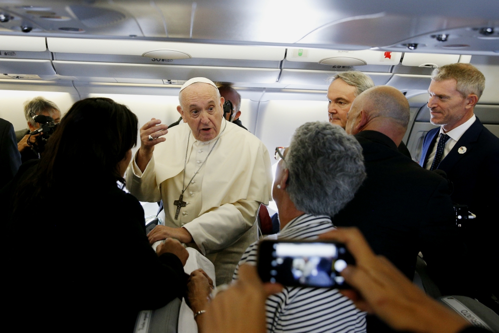 Pope Francis greets journalists aboard his flight from Rome to Maputo, Mozambique, Sept. 4. (CNS/Paul Haring)