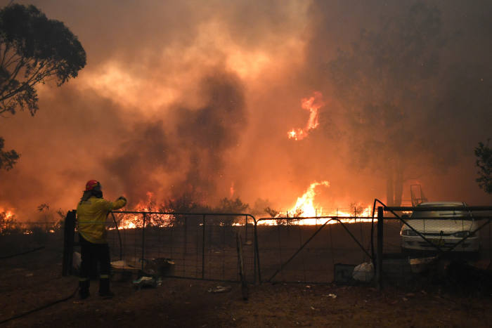 Rural Fire Service crews engage in property protection during wildfires along the Old Hume Highway near the town of Tahmoor, Australia, outside Sydney, Dec. 19, 2019. Wildfires have been burning since August and have destroyed an area comparable to the co