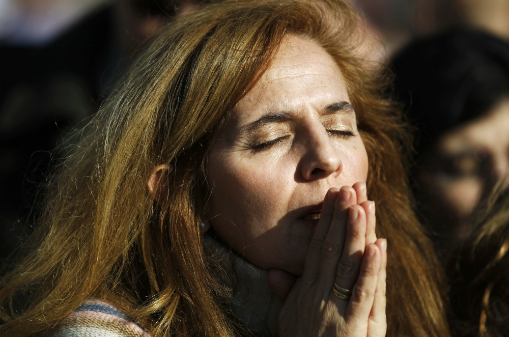 A woman prays during Mass in favor of the traditional family unit in central Madrid in this 2011 file photo. (CNS/Reuters/Susana Vera)
