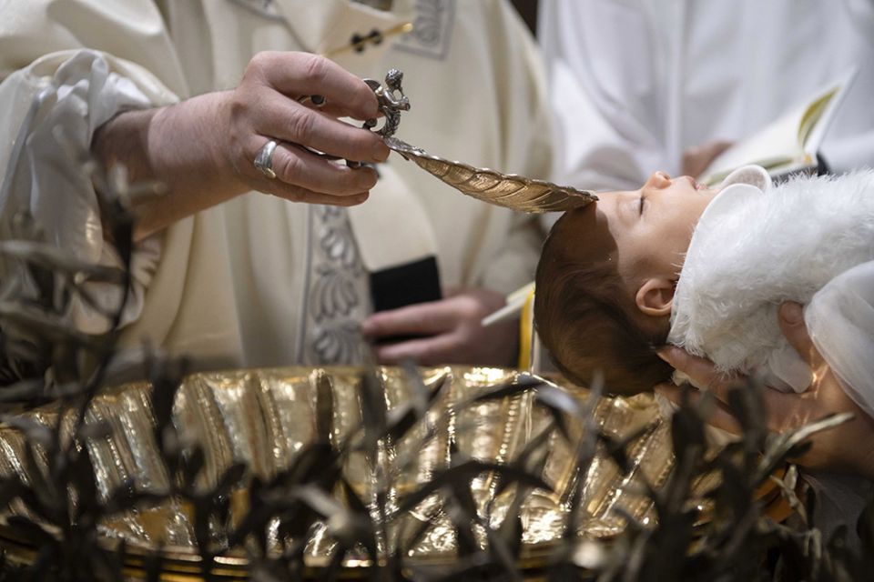 Pope Francis baptizes one of 32 babies as he celebrates Mass on the feast of the Baptism of the Lord in the Sistine Chapel Jan. 12, 2020, at the Vatican. (CNS/Vatican Media)