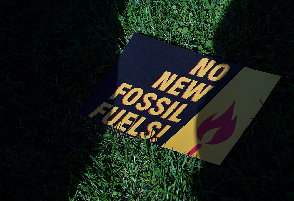 A sign protesting fossil fuels on the lawn outside of the U.S. Capitol during a protest Oct. 18, 2019, in Washington. (CNS/Reuters/Sarah Silbiger)