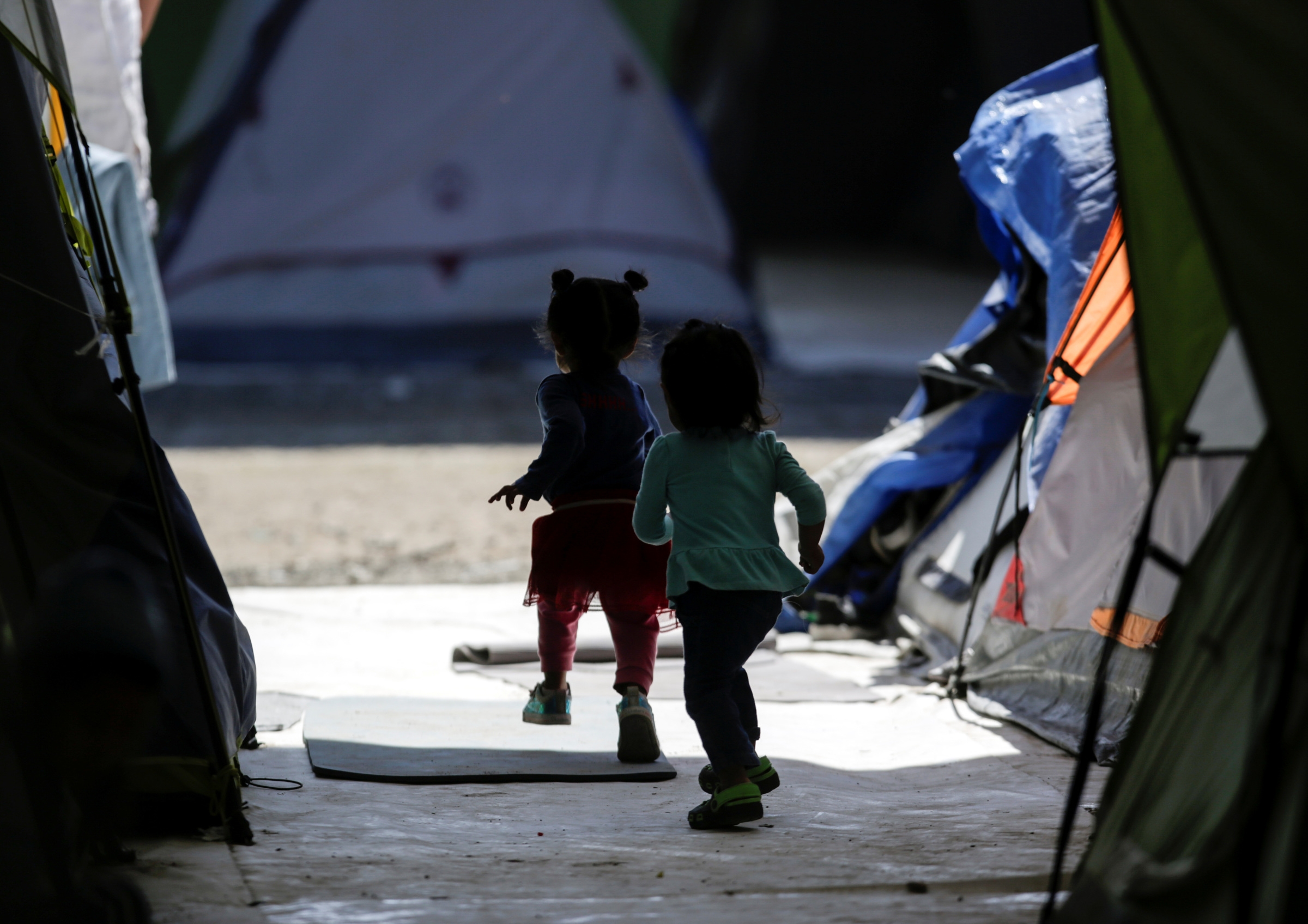 Migrant girls, who are asylum-seekers sent back to Mexico from the U.S. under the Trump administration's "Remain in Mexico" policy, are seen playing at a provisional campsite near the Rio Bravo in Matamoros, Mexico, Feb. 27, 2020. The policy is officially