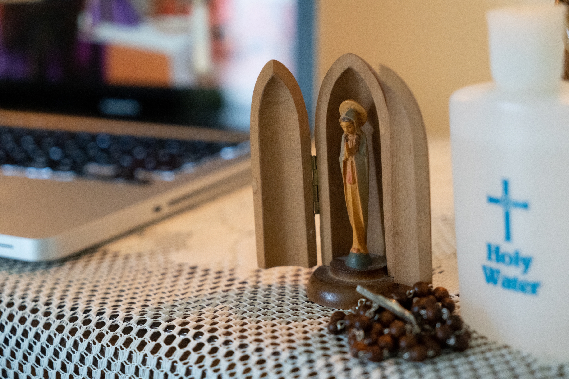 An image of the Blessed Mother adorns a prayer station set up in the home of parishioners of St. Charles Borromeo Catholic Church in Bloomington, Ind., who watched Mass livestreamed from their church March 28, 2020. (CNS photo/Katie Rutter)