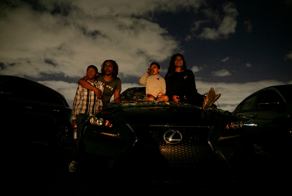 People in Fort Lauderdale, Florida, watch a movie at a drive-in theater during the coronavirus pandemic March 28. (CNS/Reuters/Marco Bello)