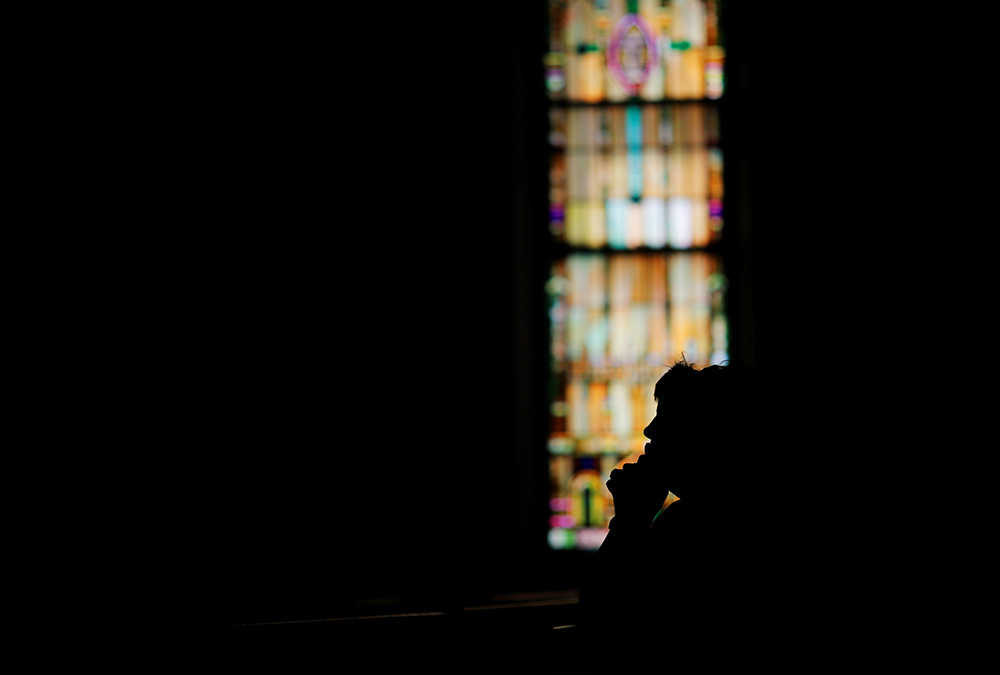 A woman prays in St. John the Baptist Catholic Church in Quincy, Massachusetts, in 2017. (CNS/Reuters/Brian Snyder)
