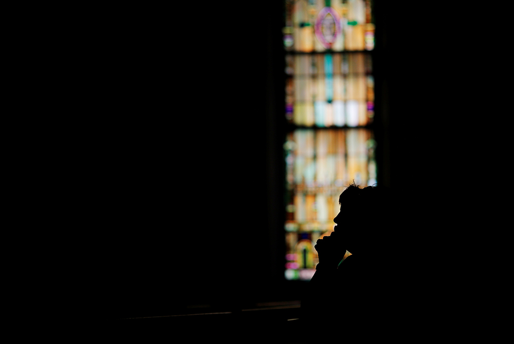 A woman prays inside a Catholic church in this 2017 file photo. (CNS/Reuters/Brian Snyder) A woman prays inside a Catholic church in this 2017 file photo. (CNS/Reuters/Brian Snyder)