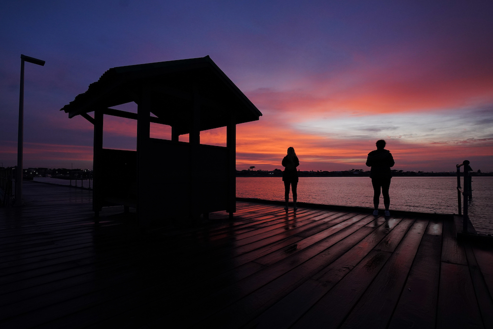 Local residents stop from their morning walk to take a photograph of the Mordialloc harbor at sunrise in Melbourne, Australia , April 3, 2020. (CNS/Michael Dodge, AAP Image via Reuters) Local residents stop from their morning walk to take a photograph of the Mordialloc harbor at sunrise in Melbourne, Australia , April 3, 2020. (CNS/Michael Dodge, AAP Image via Reuters)