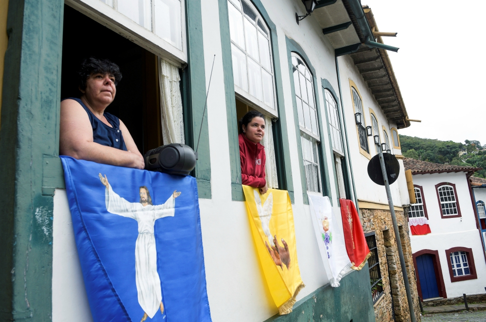 Residents listen to Easter Mass through a local radio station in Ouro Preto, Brazil, April 12, during the COVID-19 pandemic. (CNS/Reuters/Washington Alves)