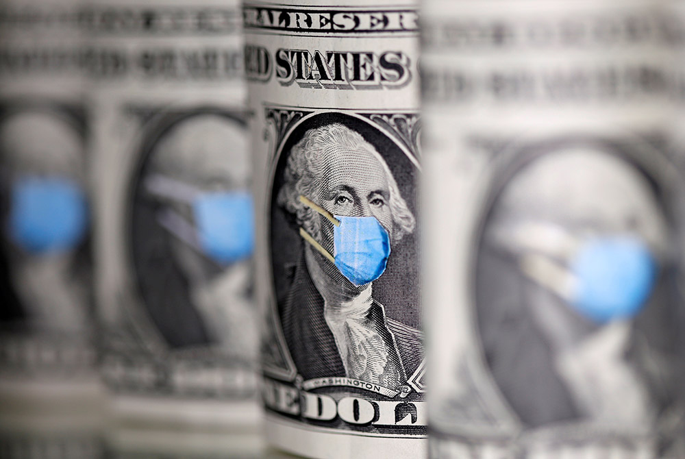 U.S. dollars are seen with face masks during the coronavirus pandemic in this illustration photo. A survey commissioned last fall by the Catholic Extension, which works to support Catholic communities in the poorest regions of the country, found that 13 o U.S. dollars are seen with face masks during the coronavirus pandemic in this illustration photo. A survey commissioned last fall by the Catholic Extension, which works to support Catholic communities in the poorest regions of the country, found that 13 o