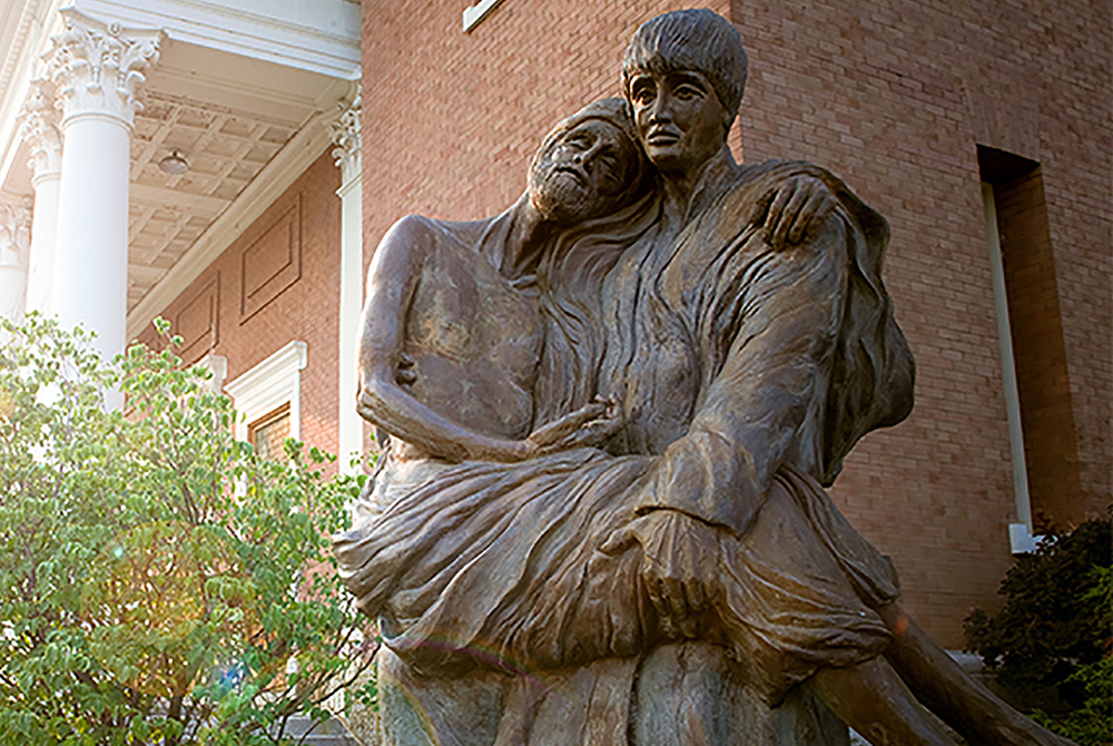 A statue of St. Aloysius Gonzaga carrying a plague victim in his arms is seen on the campus of Gonzaga University in Spokane, Wash., in this undated photo. (CNS/Courtesy of Gonzaga University)