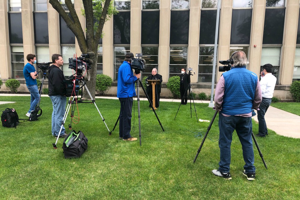 Archbishop Bernard Hebda of St. Paul-Minneapolis speaks to media May 21 outside the Archdiocesan Catholic Center in St. Paul, Minnesota. Standing behind the archbishop is Auxiliary Bishop Andrew Cozzens. (CNS/The Catholic Spirit/Tom Halden)