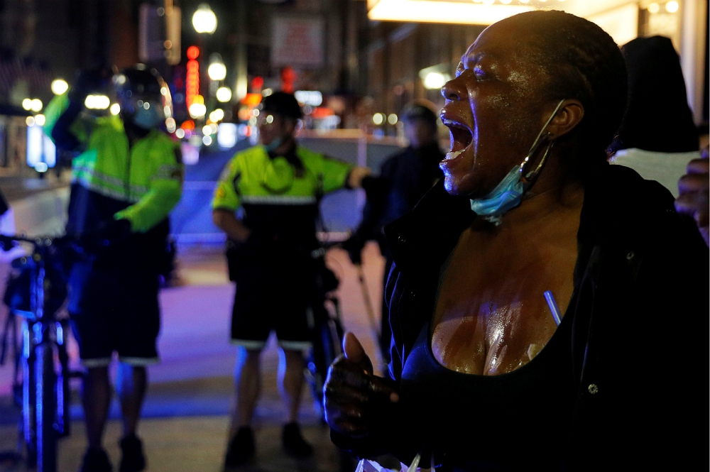 A protester in Boston screams after being affected by a chemical agent used by metro police May 31. (CNS/Reuters/Brian Snyder)