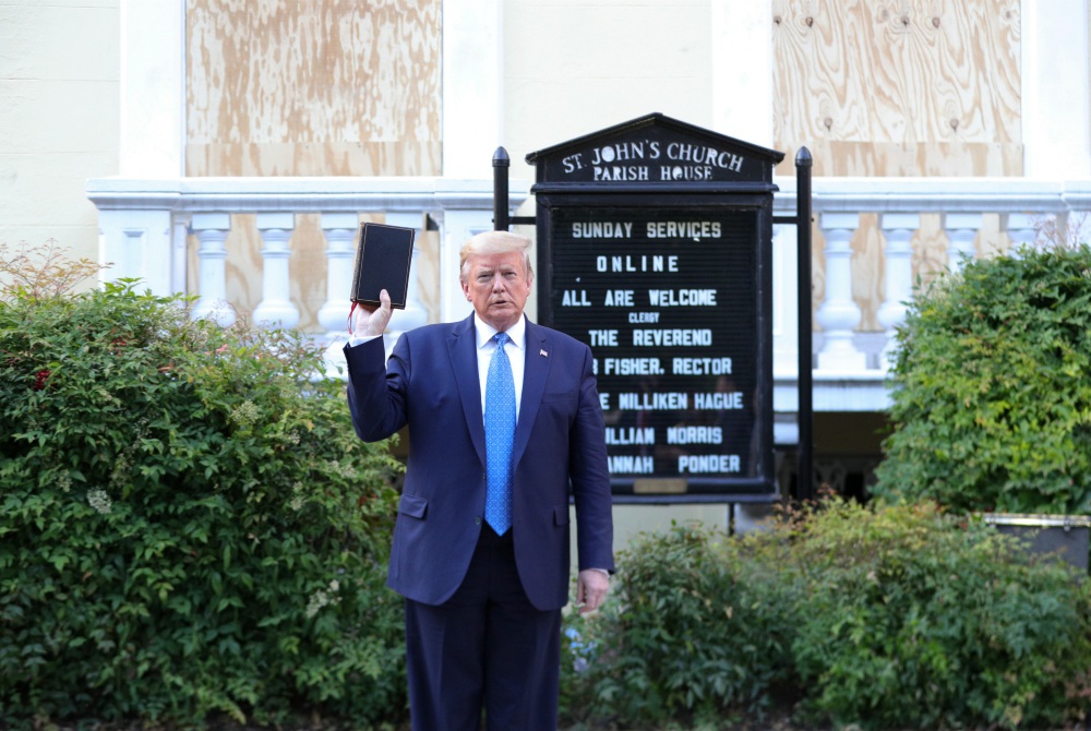 President Donald Trump holds a Bible as he stands in front of St. John's Episcopal Church in Washington June 1. (CNS/Reuters/Tom Brenner) President Donald Trump holds a Bible as he stands in front of St. John's Episcopal Church in Washington June 1. (CNS/Reuters/Tom Brenner)