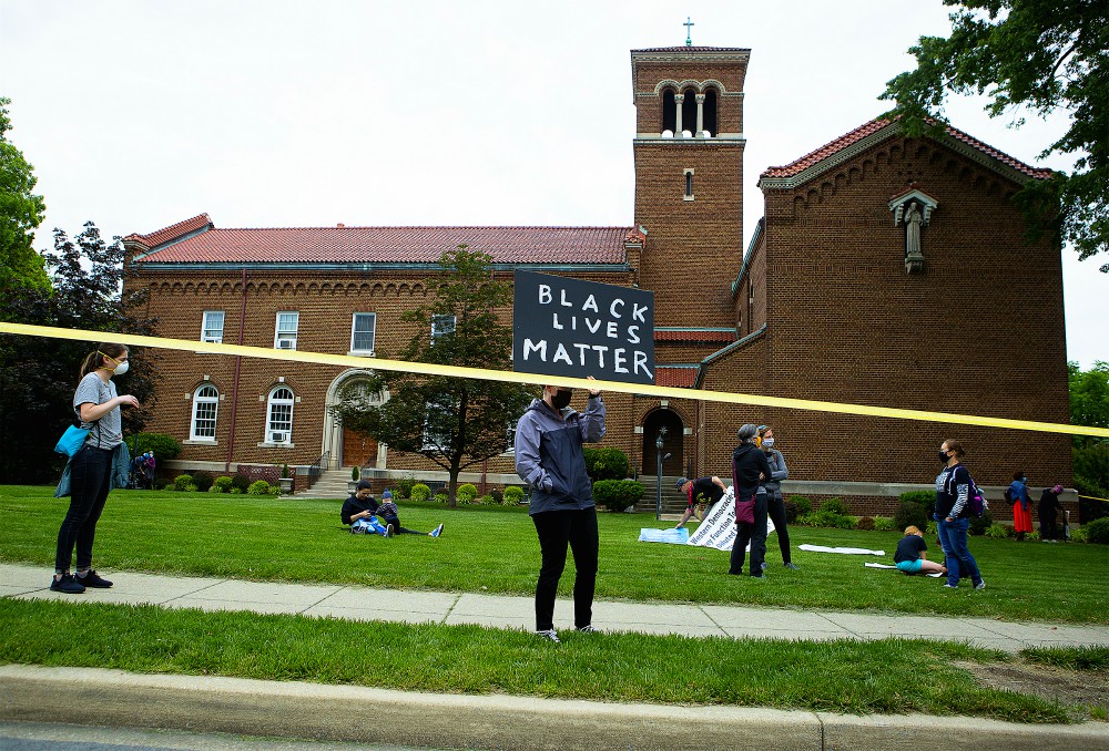 A demonstrator holds a "Black Lives Matter" sign in Washington June 2. (CNS/Tyler Orsburn)