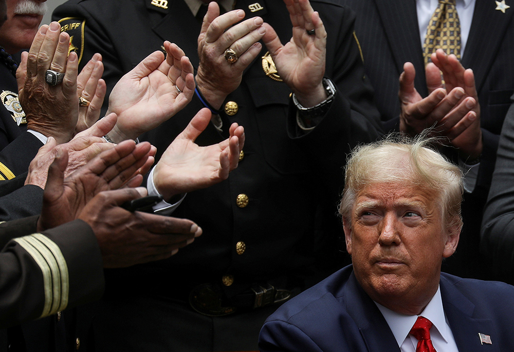 President Donald Trump listens to applause after signing an executive order on police reform at the White House in Washington June 16, 2020. (CNS/Reuters/Leah Millis)